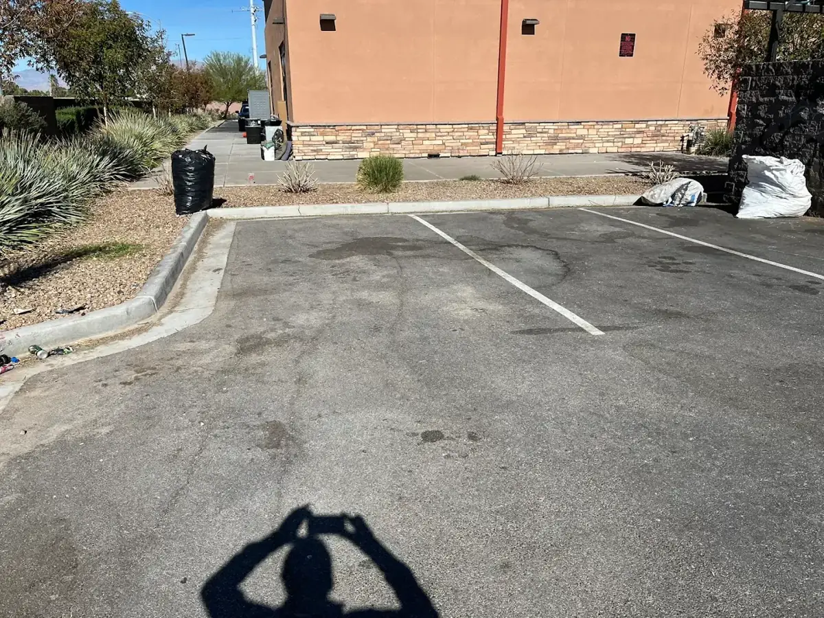 Before: commercial parking lot landscape area