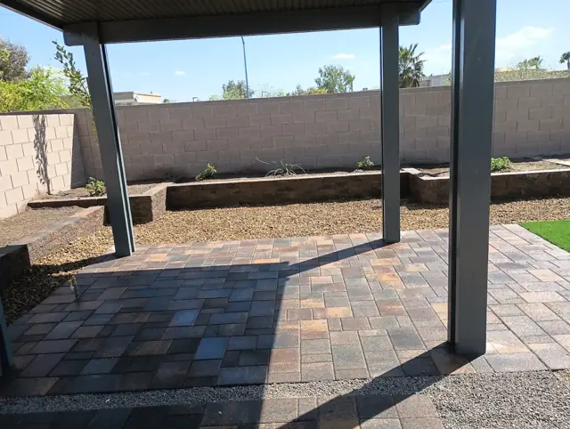Covered patio with new pavers and raised planter beds
