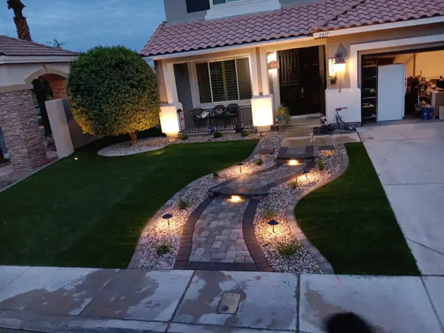 Front yard with paver walkway and landscape lighting