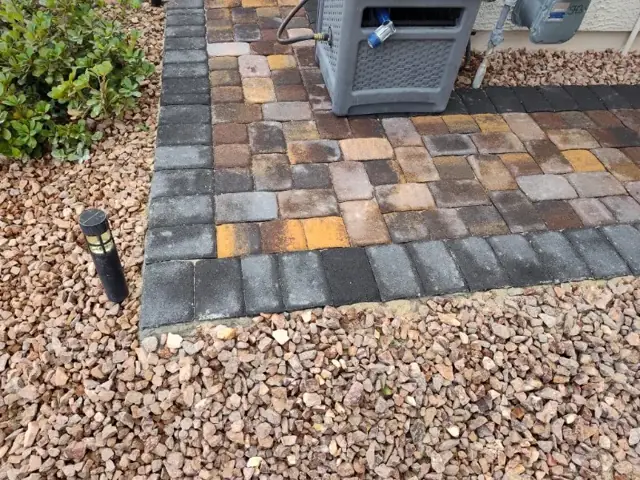 Pavers with decorative rock border and lighting